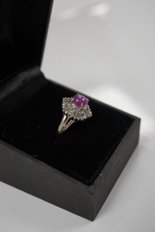 A modern platinum, star ruby and diamond cluster set dress ring, size J/K, gross weight 4.7 grams. Condition - fair to good